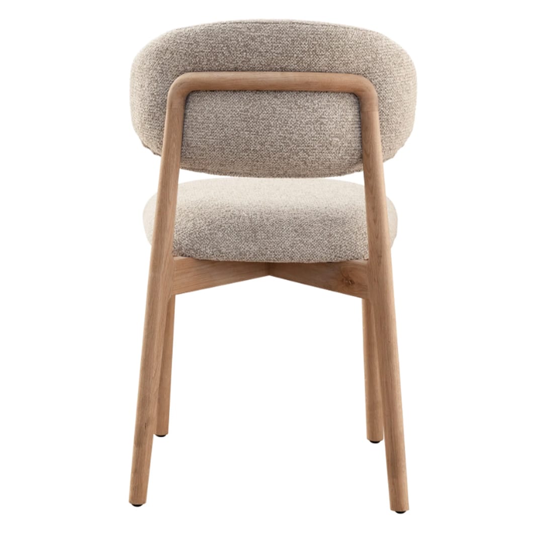 The clean, architectural lines of the Milano solid oak dining chair is a nod to modern design. Upholstered in luxurious 100% Polyester fabric and featuring a robust oak frame, this chair exudes both strength and sophistication. Whether placed at a dining table or in a reading nook, the Milano bridges the gap between contemporary and classic style. Ergonomically curved backrest. Available in two colourways.