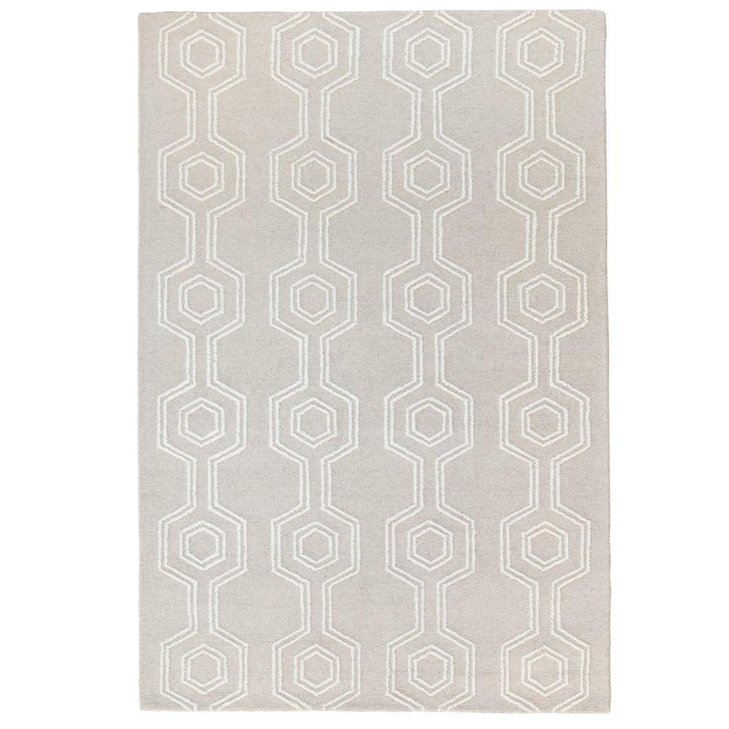 Handwoven in India this wool rug features a loop pile with a hexagon pattern and a durable cotton backing, offering a refined, texture finish. Earthy tones and subtle gradients mimic the colours and contours of mountainous landscapes, creating a grounding atmosphere in any room.