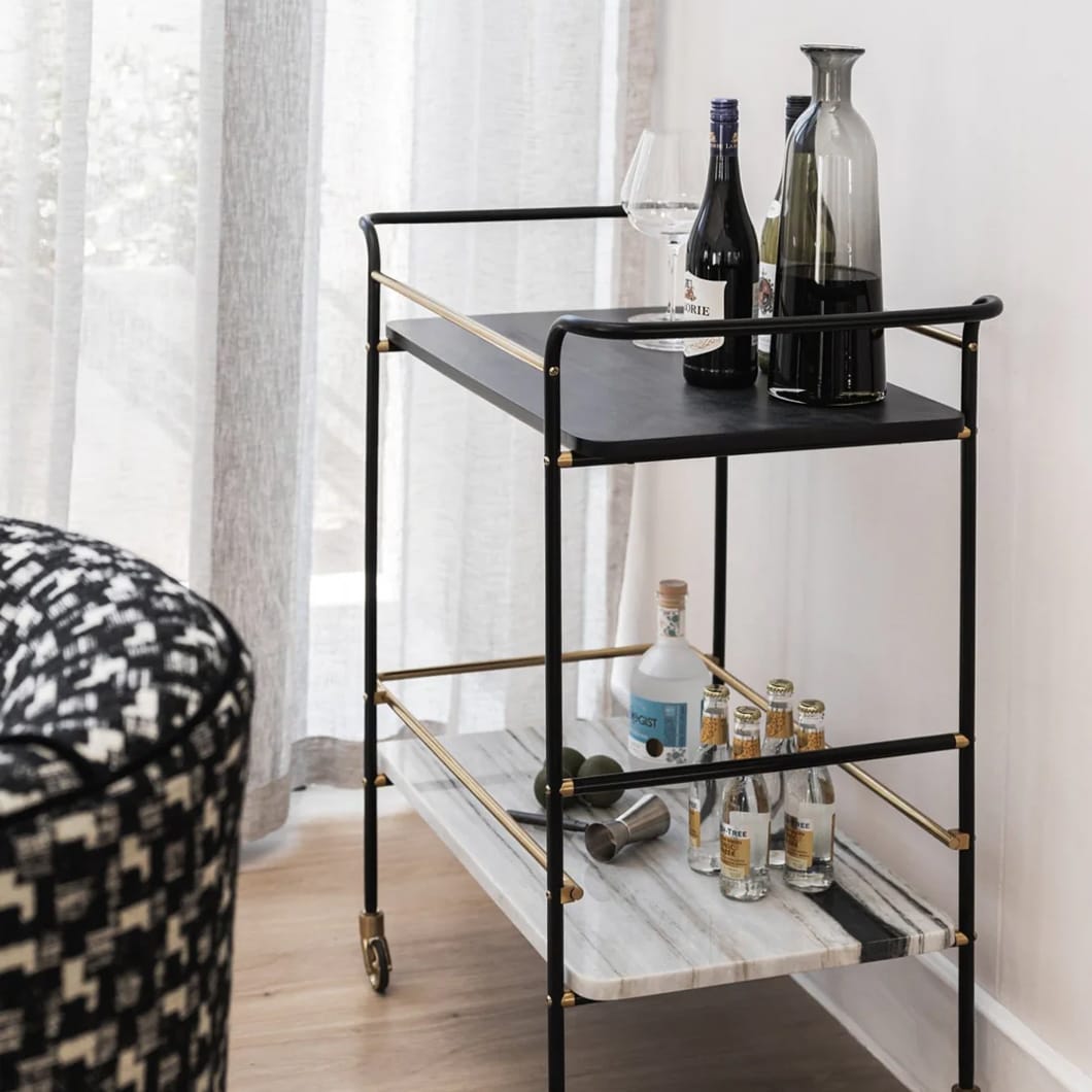 Cheers to our Sable drink trolley, the ultimate party companion that is sure to elevate your hosting game. Composed of marble, mango wood and steel, this versatile piece is perfect for showcasing your favourite drinks and glassware. A must-have for any home bar or entertainment area. Minor assembly required.