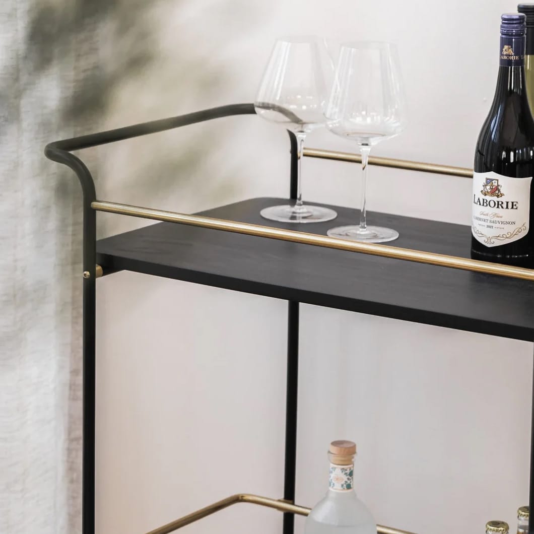 Cheers to our Sable drink trolley, the ultimate party companion that is sure to elevate your hosting game. Composed of marble, mango wood and steel, this versatile piece is perfect for showcasing your favourite drinks and glassware. A must-have for any home bar or entertainment area. Minor assembly required.