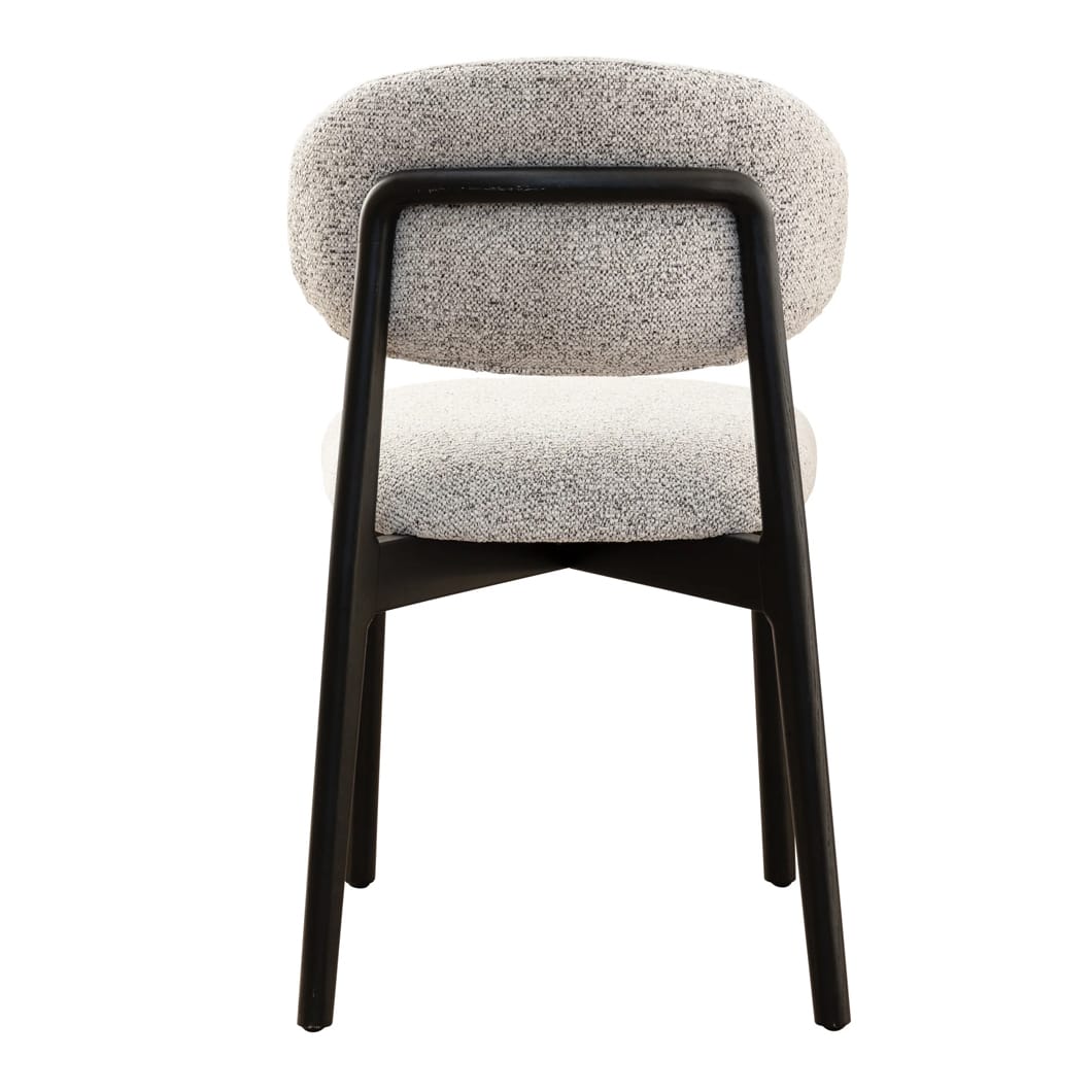 The clean, architectural lines of the Milano solid oak dining chair is a nod to modern design. Upholstered in luxurious 100% Polyester fabric and featuring a robust oak frame, this chair exudes both strength and sophistication. Whether placed at a dining table or in a reading nook, the Milano bridges the gap between contemporary and classic style. Ergonomically curved backrest. Available in two colourways.